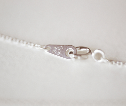 Layered sterling silver Franco chains styled with a minimalist neckline